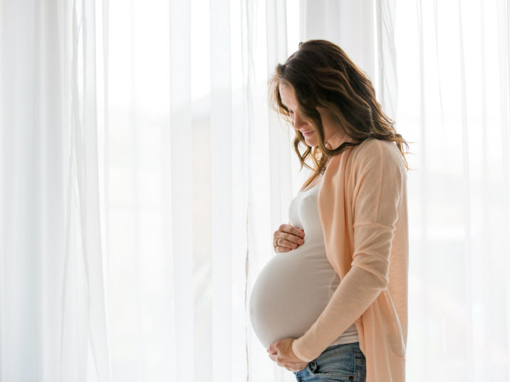 pregnant holding baby