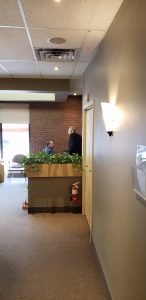 Dr. Ken Peever is discussing the Erin Mills Optimum Health fish tank in Mississauga